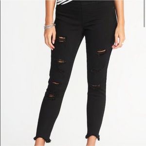 Distressed mid-rise black jeggings